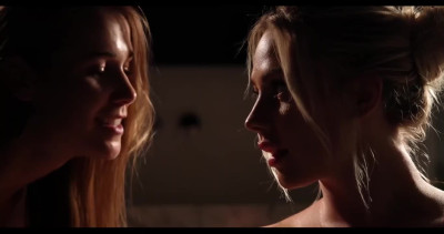 Two beautiful blondes have erotic fun in a warm bath.