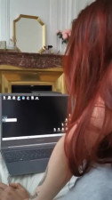 Redhead whore gives handjob and blowjob while guy watches porn