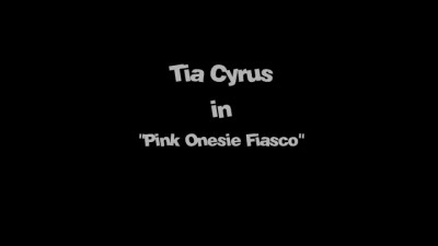 A lustful MILF in a pink jumpsuit satisfies her stepson's big cock.