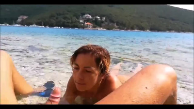 Public beach oral foreplay ends with cumshot on girl's shaved pussy