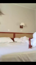 Brunette thrusts a hyper realistic dildo into her unshaven pussy after a little stripping