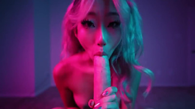 Cute Asian girl does blowjob in a neon room
