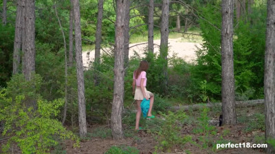 The petite beauty goes into the woods and starts masturbating her crotch.