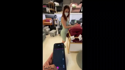 Guy presses the vibrator button while he and the girl are walking around the mall