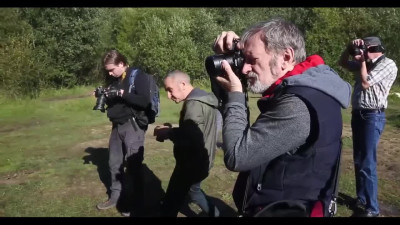 Behind the scenes of naked models having a photoshoot in the woods