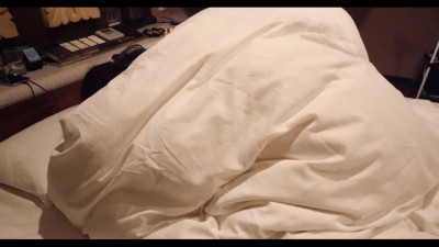 Asian couple fuck under the covers in missionary position.