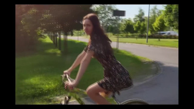 Amateur teen is riding a bike with a dildo in a public park