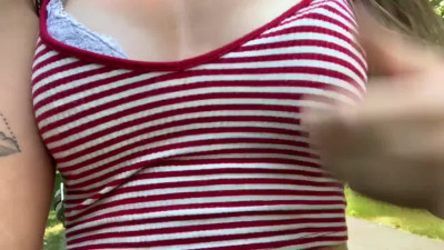 Skinny slut flashes her boobs and pussy in the public park