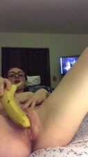 Nerdy bitch uses banana to satisfy herself. She puts it deep inside!