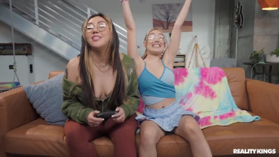 Violet Gems and Tomie Tang play the console to determine who will get more orgasms in their next session